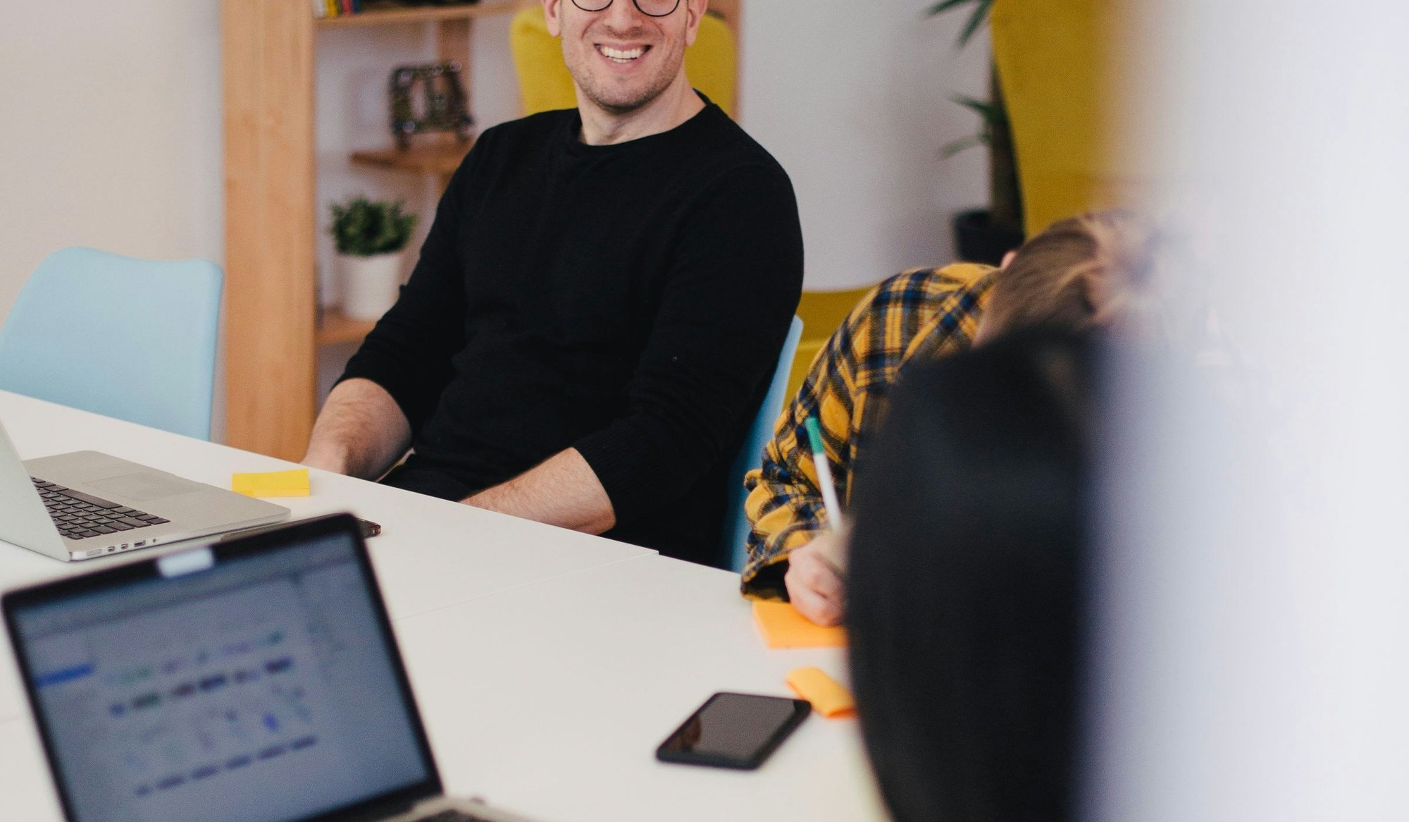 a man smiling at a woman during a meeting