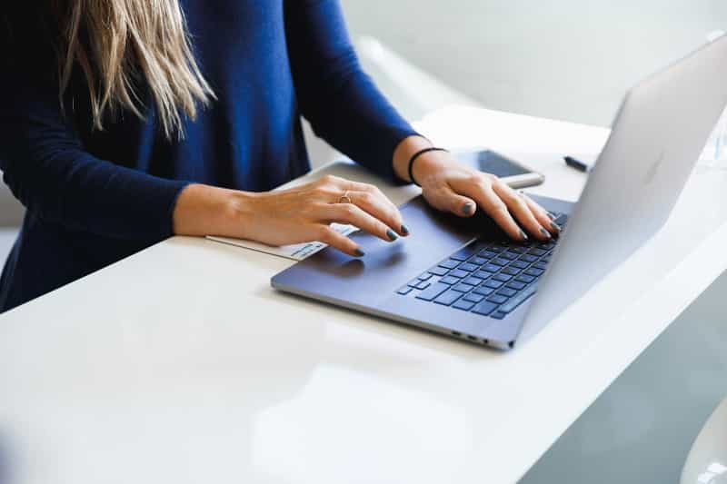 a person typing at a laptop