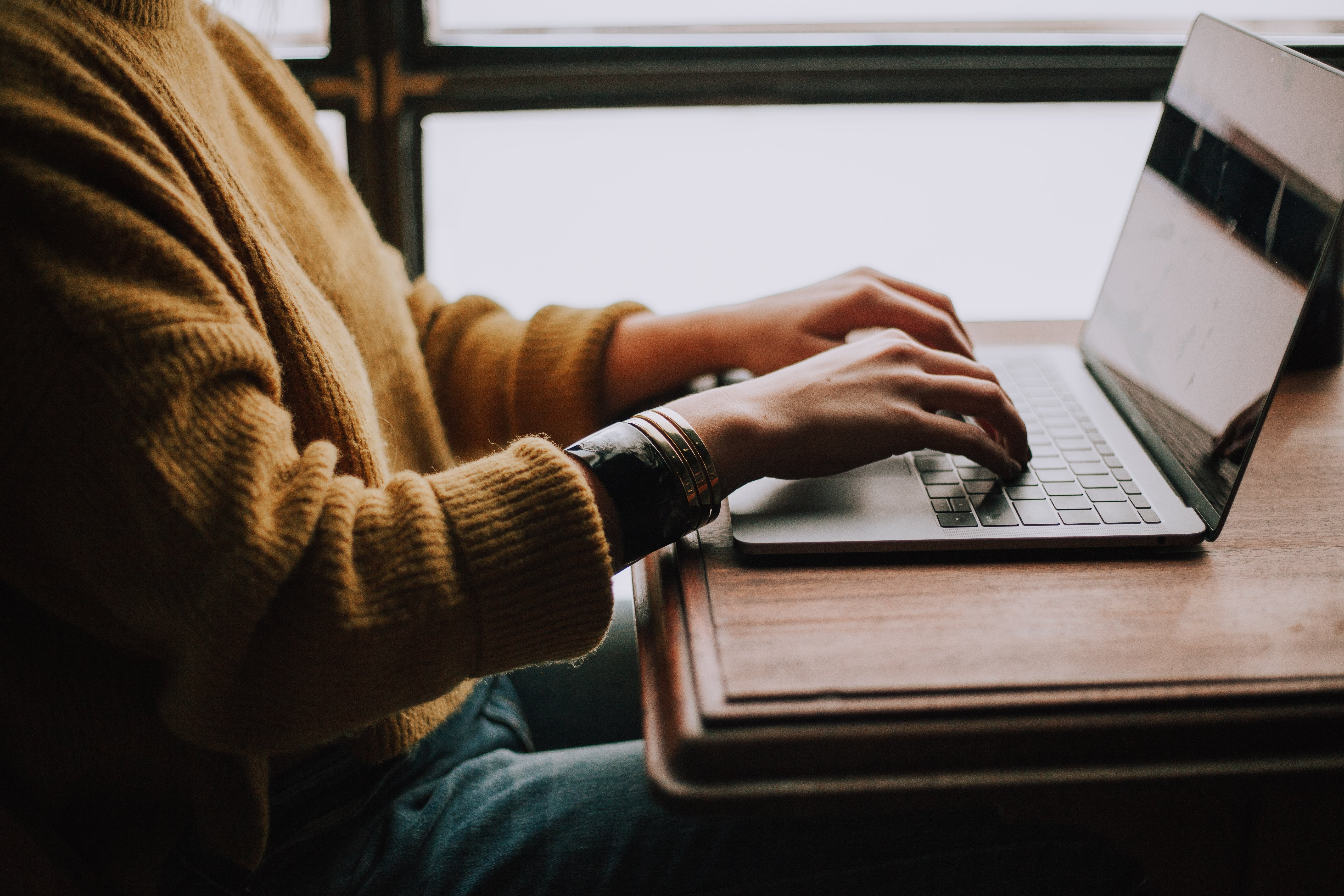 person typing at computer